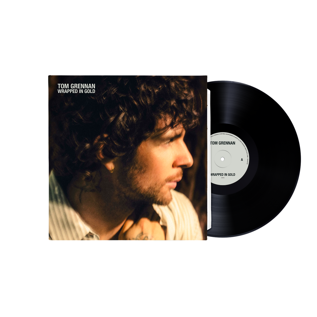 Tom Grennan's 'Wrapped in Gold' vinyl record album, showing the illustrated black cover on the left and the black vinyl record partially pulled out on the right against a white background.